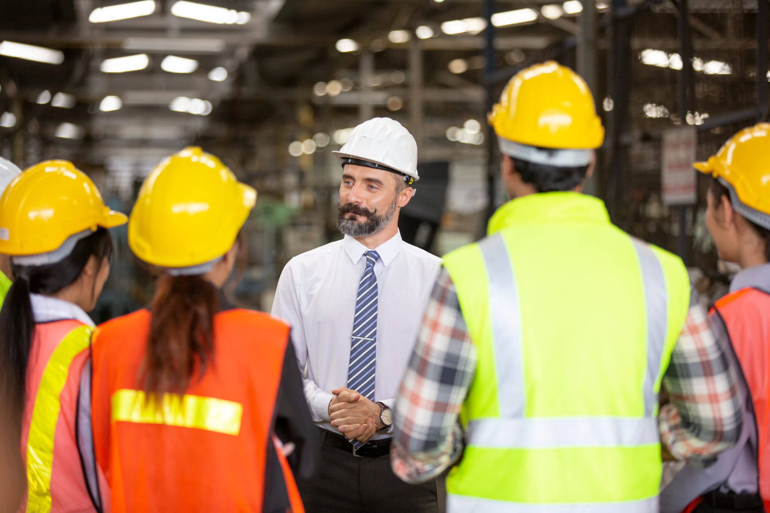portrait of foreman or worker are working in factory.